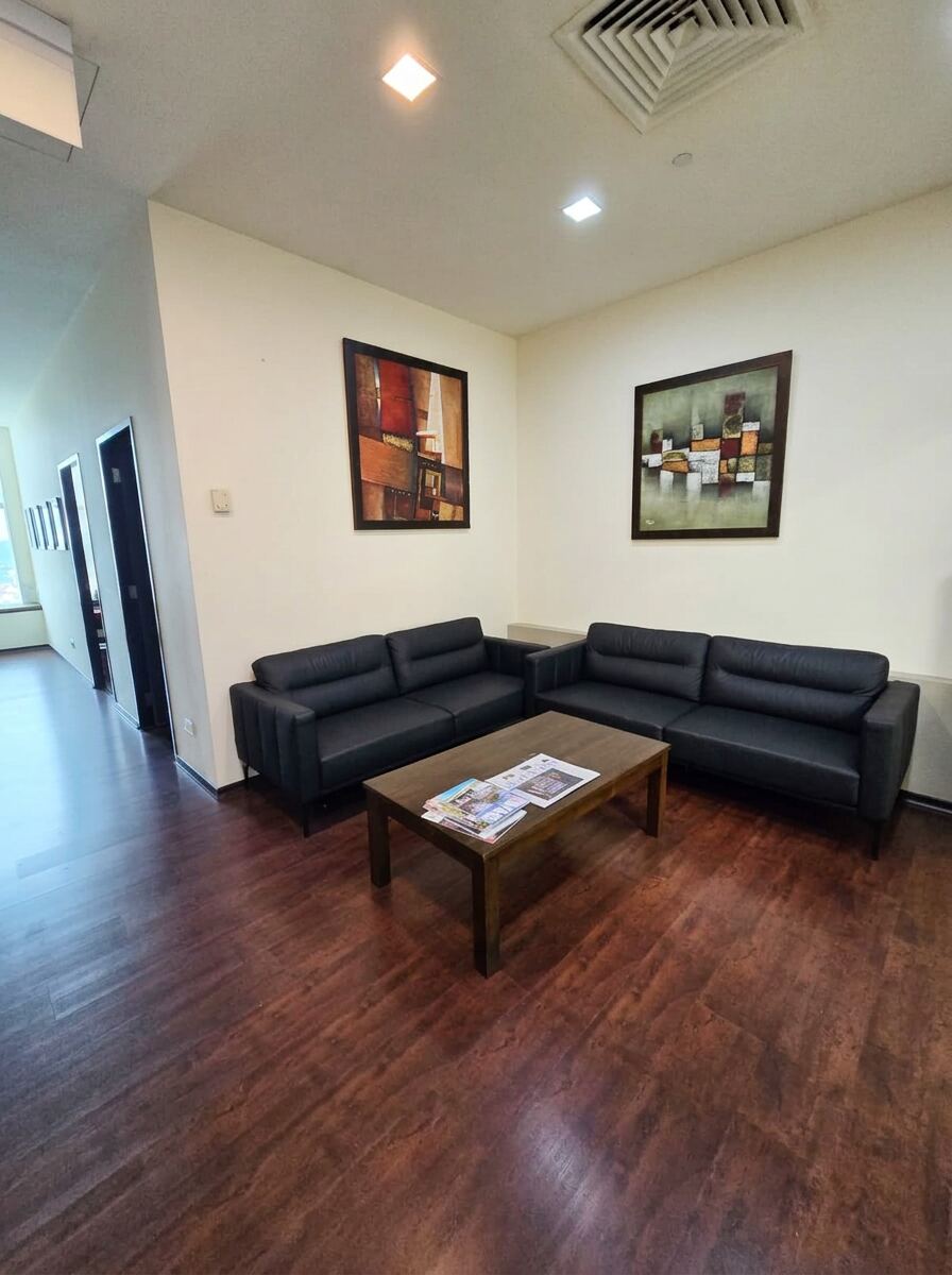 Waiting room with leather sofas and artwork